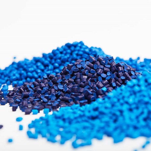 Different shades of blue polymer beads that will be melted for plastic injection molding