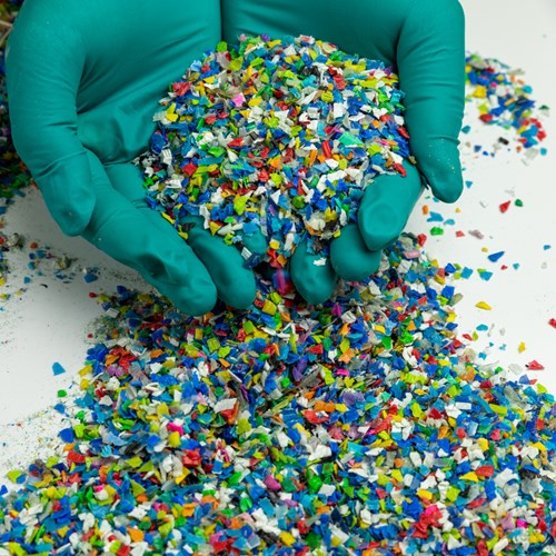 A handful of plastic resin pellets for plastic injection molding